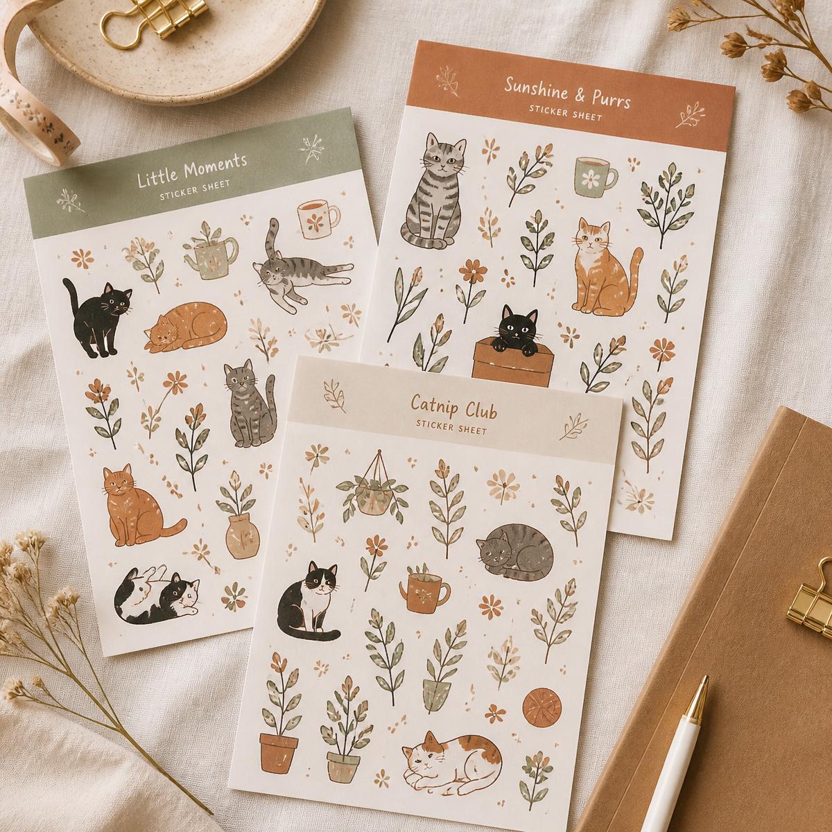 Hand-drawn cat sticker sheets laid on linen